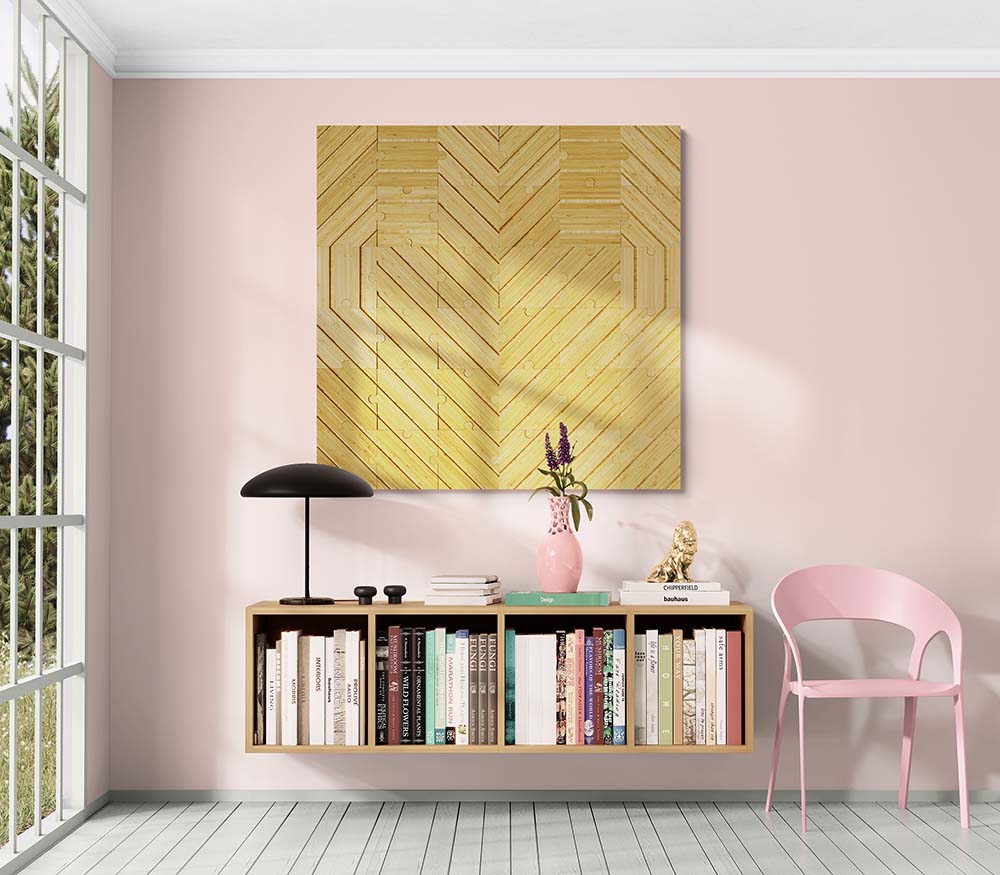 Plyboo puzzle heart on the wall in a pink office space above a low bookshelf